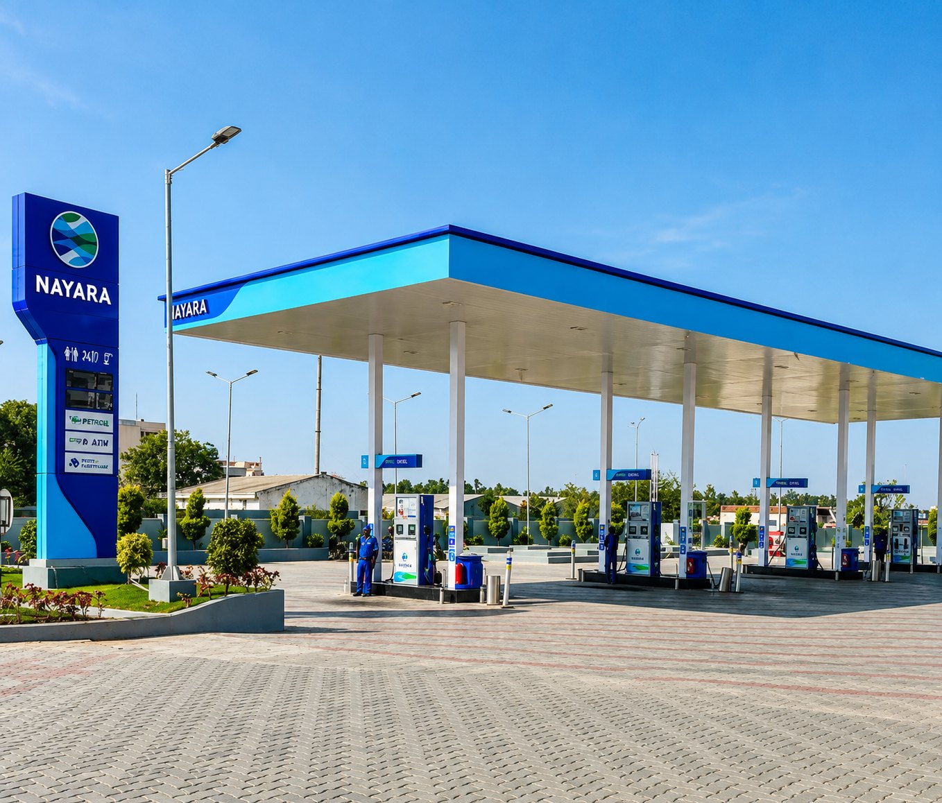 Nayara fuel station with a wide canopy, pump islands and price pylon under clear skies